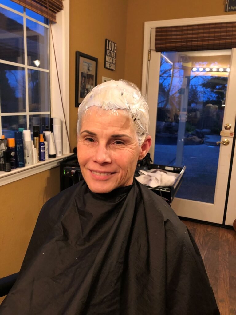 Bleaching my hair to lift my dark color out. To heat things up, my head is wrapped in plastic wrap.
